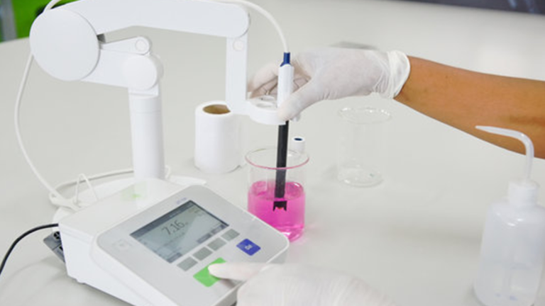 chemist using bench ph meter